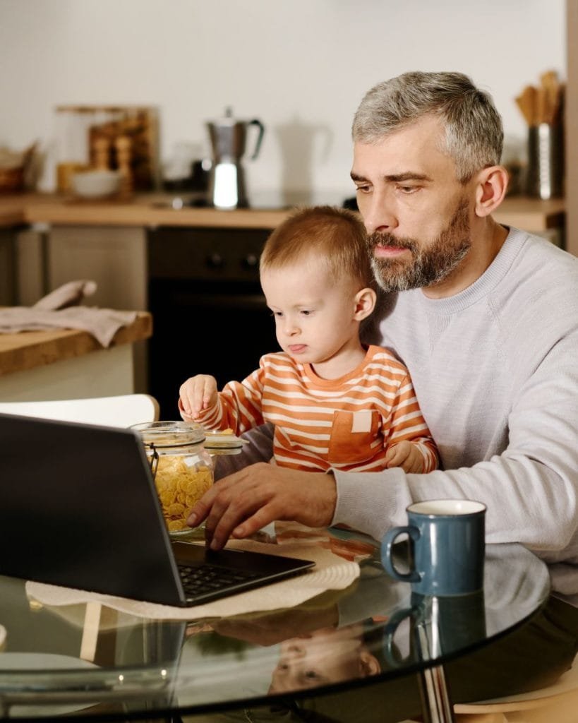 Dad and child watch together. 